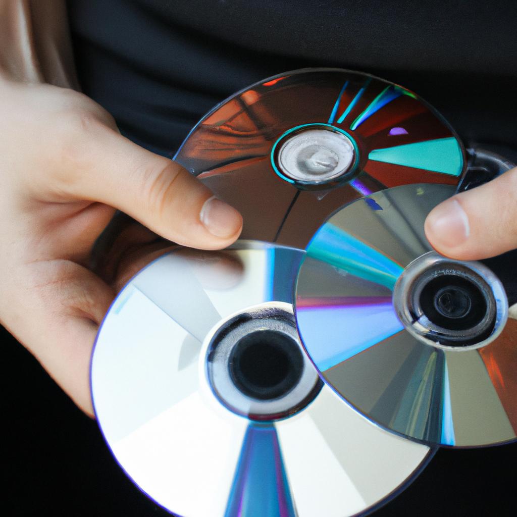 Person holding CDs, reviewing ratings