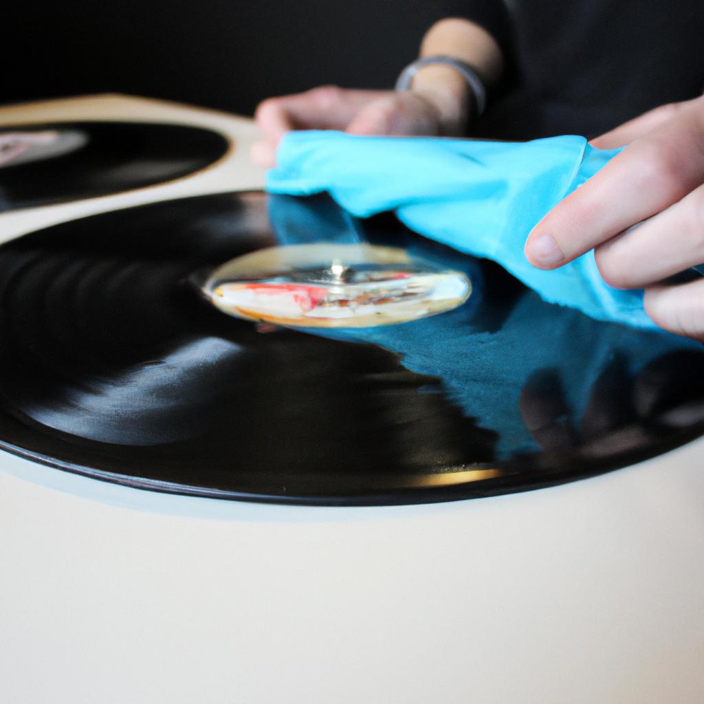 Person cleaning vinyl records professionally